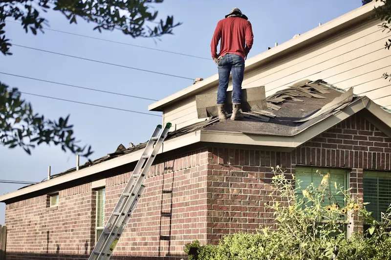 Professional roofer working on a residential roof in Hollister